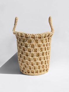 a crocheted basket sitting on top of a white surface