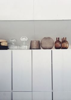 a shelf with vases and other items on it