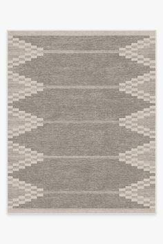 an area rug with grey and white designs on the front, in two different colors