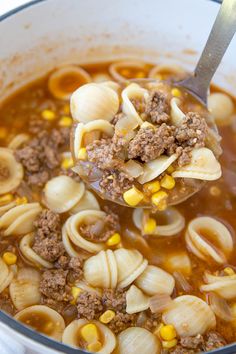 a spoon full of soup with noodles and ground beef