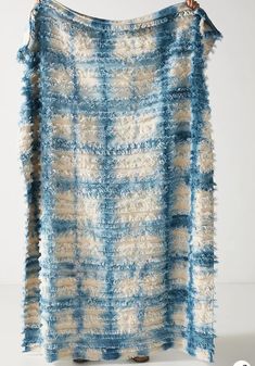 a blue and white blanket hanging on a wall