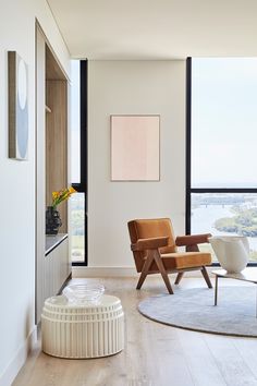 a modern living room with large windows overlooking the city