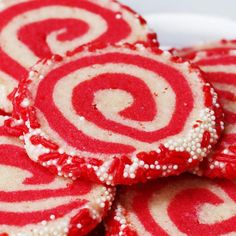 some red and white cookies are on a plate