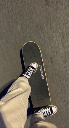 a person standing with their feet on a skateboard