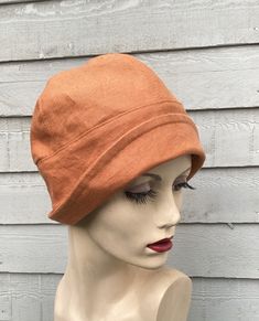 Enhance your summer outfits with this charming Orange Linen Small Brim Cloche Hat. Beautifully handcrafted with attention to detail, this unique accessory boasts a timeless design that will elevate your ensemble. Made from high-quality linen, this hat is breathable and lightweight, making it perfect for those warm sunny days. Effortlessly stylish and versatile, this handmade cloche hat is a must-have addition to your hat collection. Add a pop of color and a touch of elegance to your look with this fabulous accessory. *Size medium to fit head size 57cms/22.4 inches. *May be hand washed as I have pre-washed the linen to prevent shrinkage. Iron with another piece of fabric protecting the hat to prevent shine. To see more of my hats please click https://www.etsy.com/uk/shop/OverToYou I design, Orange Cotton Summer Hat, Orange Cotton Beach Hat, Summer Cloche Sun Hat, One Size Fits Most, Fitted Brimmed Summer Hat, Adjustable Orange Sun Hat With Curved Brim, Adjustable Sun Hat Cap For Kentucky Derby, Fitted Summer Cap, Linen Hat With Short Brim, Linen Short Brim Hat