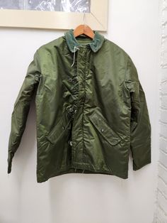 Vintage Military Issued OD Green Extreme Cold Weather Permable Jacket Size-Small Condition-USED in GREAT shape for its age-see pics Dated-1981 NSN# 8415-00-349-9313 Made in the USA! check us out at www.armysurpluswarehouselexington.com Retro Green Utility Jacket For Winter, Retro Khaki Outerwear For Outdoor, Retro Green Outerwear For Outdoor, Vintage Solid Color Outdoor Outerwear, Vintage Winter Windbreaker, Retro Green Outerwear For Outdoors, Vintage Green Utility Jacket For Outdoor, Vintage Green Outerwear For Cold Weather, Retro Green Outdoor Outerwear