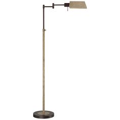 a floor lamp with a white shade on the top and a black base, in front of a white background