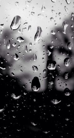 black and white photo of rain drops on window