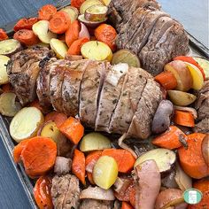 a tray filled with sliced up meat and veggies