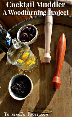 a wooden barrel filled with fruit next to two small bowls and a bottle of alcohol