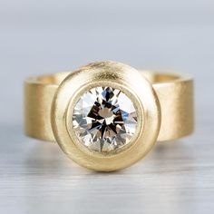 a gold ring with a diamond in the center