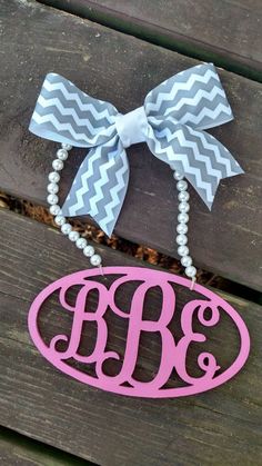 a monogrammed necklace with a bow on it