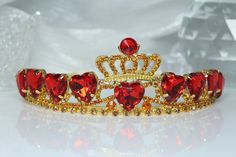 ♚ Crown Design ♚ This beautiful red heart crown is inspired by the Queen of Hearts hair and costume. ♚Material♚ Zinc alloy, red acrylic diamonds, rhinestones. ♚ Headpiece Size♚ 15.5cm L * 13.5cm W * 4.8cm H. Suitable for girls, women to wear, suitable for most people's headdress. ♚ Widely Applicable Occasions♚ Sparkling rhinestone tiara is perfect for any party, create a stunning sparkling tiara for your very special day, add fun to your party and make sure you catch everyone's attention. ♚ Comfortable to wear ♚This crown is just like a regular tiara without a hair comb, making it more comfortable for you to wear! Queen Of Hearts Hair, Red Heart Crown, Queen Of Hearts Crown, Quinceanera Crown, Girls Tiara, Crown Gold, Heart Crown, Gold Tiara, Rhinestone Tiara