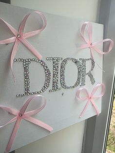 a canvas with pink bows and the word daddy written on it