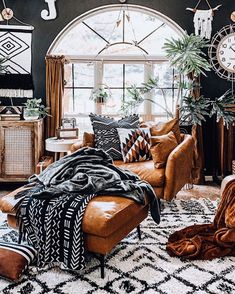 a living room filled with lots of furniture and decor on top of a white rug