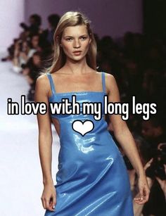 a woman in a blue dress walking down a runway with the words i'm in love with my long legs