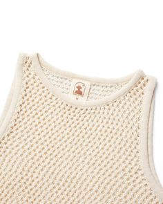 Timeless celebrant of hot sands and dark tans, the Málaga Crochet Knit Tank features a soft cotton feel and a lightweight, unlined exposure that transcends the limits of blissfully long summer days. Notable attributes include a wide neck and arm openings for the most relaxed wear. Don’t forget to pair with the Málaga Short! Designed with love in California Unlined Crochet Knit Relaxed Fit 60% Cotton, 40% Polyester Made in Indonesia Ships within 1-2 business days. Beige Cotton Crochet Top For Summer, Cream Crochet Lace Cotton Top, Cream Cotton Crochet Top, Cream Cotton Crochet Knitted Top, Beach Crochet Top In Cream With Pointelle Knit, Cream Cotton Crochet Top For Vacation, Cream Crochet Top With Knit Fabrication For Summer, Cream Cotton Crochet Summer Top, Summer Cream Cotton Crochet Top