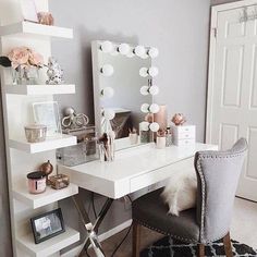 a white desk topped with a mirror next to a chair and shelf filled with items