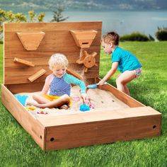 two children playing in an outdoor sandbox