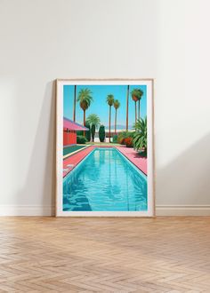 a painting is hanging on the wall next to an empty room with a pool and palm trees