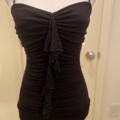 This Top Is Super Cute. It Has Spaghetti Straps That Are Adjustable. It Has Rushing And Ruffles In The Front. In The Back It Crisscross Is With Scalloped Detail In The Back. Fitted Tops With Built-in Bra And Ruffled Straps, Flirty Camisole Top With Ruffles, Flirty Ruffled Camisole Top, Black Ruched Tank Top For Party, Chic Black Ruched Tank Top, Black Ruched Cami Top, Fitted Ruched Top With Ruffled Straps, Fitted Ruched Top With Spaghetti Straps, Flirty Strapless Fitted Tank Top