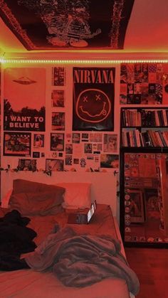 a bed room with a neatly made bed and posters on the wall