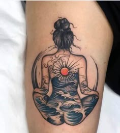 a woman sitting in the middle of a body of water with her back turned to the camera