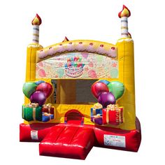 an inflatable birthday bouncer with balloons and presents on the front is shown