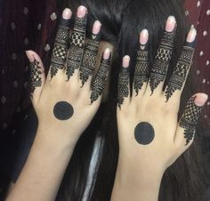 two hands with henna tattoos on them