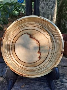 a wooden bowl sitting on top of a table