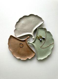 three leaf shaped dishes sitting next to each other