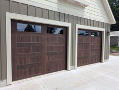 two brown garage doors in front of a house