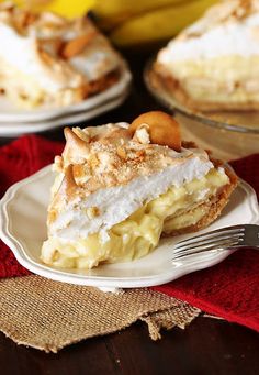 a piece of pie on a plate with a fork next to it and bananas in the background