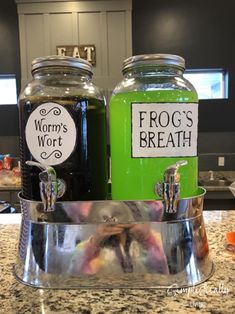 two glass jars with frog's breath and worm's breath labels on them