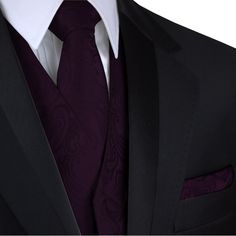 a man wearing a black suit with a purple tie and pocket square on his lapel