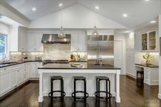 a large kitchen with white cabinets and black counter tops is featured in the home appliance website