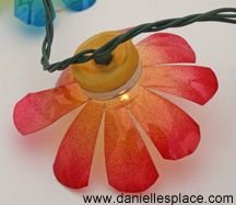 a flower shaped string light on a white table