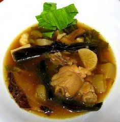 a white plate topped with soup and vegetables