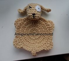 a crocheted sheep is sitting on top of a table