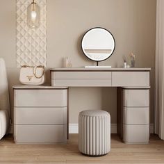 a dressing table with stools and a round mirror on the wall above it in a beige room