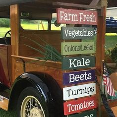 an old fashioned car with signs on the side of it that read farm fresh, vegetables, onions, leeks, kale bee's, turris, tomatoes, tomatoes, tomatoes, tomatoes, tomatoes, tomatoes, tomatoes, and more