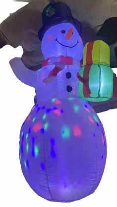 a large inflatable snowman with lights on it's head