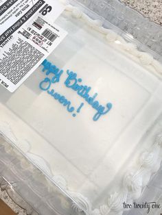 a birthday cake with the words happy birthday queen in blue frosting on it's side