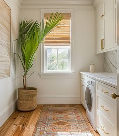 a white washer and dryer in a small room