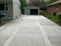 an empty driveway in front of a house