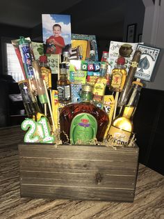 a wooden box filled with lots of liquor and other items on top of a table