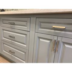 an image of a kitchen setting with cabinets and counter tops that are painted in light gray