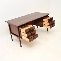 a wooden desk with two drawers on each side