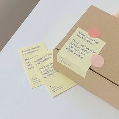 an open box with two sticky notes attached to it and a piece of paper sticking out of the inside