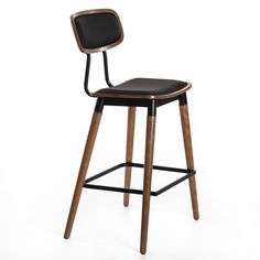 a wooden stool with black leather seat and backrest on an isolated white background photo